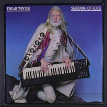 LP EDGAR WINTER STANDING ON ROCK